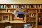 In the library, a vintage Louis Poulsen PH 5 pendant adds a touch of color.  Photo 12 of 16 in PSJ25 Patio by Kumiko Toft from Designer and Artist Tom Deacon Goes Back to the Drawing Board to Re-Renovate His Home and Studio