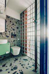 Interior design studio Mistovia combines chunky terrazzo, glass bricks, shiny surfaces, and bold colors to dazzling effect.  Photo 4 of 6 in What’s the Right Fragrance for My Bathroom?