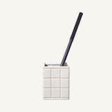 The toilet brush has never looked as beautiful as it does in this container. Clad in white ceramic tile, this vessel dresses up the unsung hero of the bathroom.