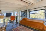 A workspace above the primary bedroom looks out to the ocean through clerestory windows.