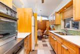 "The compact galley kitchen features a working vintage range by Frigidaire, bright colors, stained wood cabinets, and plenty of lighting," Kinney adds.&nbsp;