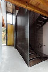 This custom staircase is made from wood and steel, and is enclosed in a design that the craftsmen made themselves. "I think it's one of my favorite moments in the house,