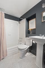The parlor level also includes a full bathroom with a pedestal sink and shower/tub.