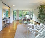 Floor-to-ceiling sliding glass doors connect the open kitchen, living, and dining area to the backyard and pool area.  Photo 7 of 13 in A Wood-and-Glass Midcentury by Craig Ellwood Lists for the First Time Since 1965
