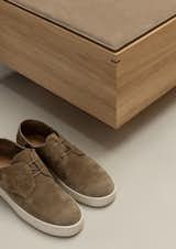 A dark-stained oak joint in the bench mirrors the stitch in the vamp of the sneaker. "They’re not just ornamental, they’re functional elements, defining the designs in an understated manner," says Norm.