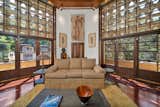 Living Room Lloyd Wright built the Derby House using wood, glass, and ornamental concrete textile blocks stenciled with intricate, Mayan-influenced patterns.   Photo 2 of 7 in Frank Lloyd Wright Jr.’s Landmark 1926 Derby House Seeks $3.3M in Glendale, CA