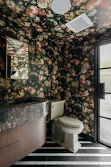House of Hackney wallpaper adorns the walls in the primary bath and powder rooms.