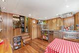 “Paneled walls and ceilings are made of American red oak, pine, hickory, pecan, and poplar,” says the listing agent. Brazilian walnut floors run throughout the interior.  Photo 5 of 9 in A Massive Converted 1950s Houseboat Is Looking for a New Owner in London
