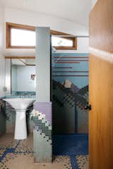 "The home’s mountainous backdrop was uniquely designed into the guest bathroom by mosaic tiler Paul Clarke," says the listing agent.