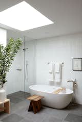 The freestanding tub in the guest suite bathroom sits beneath a four-foot square skylight.