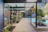 The design embraces a strong indoor/outdoor connection with walls of glass that connect the main living areas to the rear patio and swimming pool.  Photo 16 of 18 in A Respectfully Renovated “Super Eichler” Asks $2.5M in Walnut Creek, CA