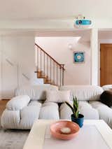 Rebecca removed the wall in the entrance hallway to open up the living area and added storage units under the staircase.