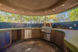 A full outdoor kitchen area, shower, and pool bath complete the cabana shelter. There is a private elevator for convenience  Photo 14 of 16 in An Earthshipesque Home by a Frank Lloyd Wright Protégé Hits the Market for the First Time