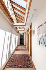 “Six of the seven sleeping areas are positioned on the lower level of the house, each well-proportioned, private, and soundproofed room set adjacently along a beautifully light hallway,” says the listing agent. “A pitched glass ceiling allows dramatic shards of light to penetrate the lower floor, complete with handcrafted timber hatches that can shutter off the light or preserve heat in the winter.”  Photo 7 of 14 in For £1.65M, This English Home With an Attached Greenhouse and Walled Garden Could Be Yours