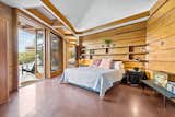 Full-height windows and glass doors connect one of the bedrooms to the yard.  Photo 10 of 42 in Robertson by Cynzia Sanchez Studio from One of Only Three Frank Lloyd Wright Homes in Virginia Is on the Market for $2.9M