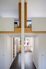 Wooden details are echoed throughout the second level, from the stairs to the built-in shelving.
