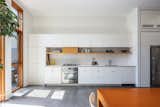 A few steps down to the kitchen with a wall of appliances (Bertazzoni oven and stovetop, Fisher Paykel refrigerator, hidden Broan vented hood, Blomberg dishwasher) ample counter space and an appliance cabinet with multiple outlets