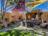 "From the pool, moving out into the back courtyard lawn, an outdoor kitchen with a built-in barbecue grill, stained cement countertop, and copper sink provides a wonderful outdoor dining and gathering space," says the listing agent.