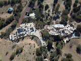 Situated on 11 desert acres in Santa Fe, New Mexico, the expansive property includes two separate houses with a total of five bedrooms and seven baths.