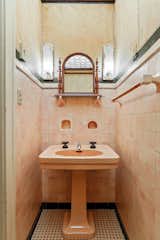Pink tile adds a playful touch in one of the bathrooms.