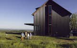 The communal lodge channels the black creosote siding of a traditional tobacco barn.