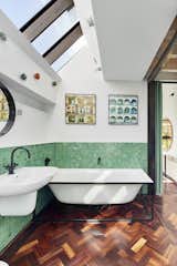 Pale-green tiles in the en suite bath match the curtains separating the bedroom from the study.