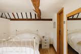 Another bedroom on the level is adorned with timber ceiling cladding.&nbsp;