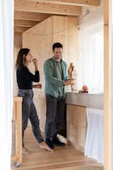 Pau (left, with Victoria) was inspired by small but functional spaces from around the world that maximize their natural surroundings, such as traditional wood-framed cabins in Norway and tiny Uruguayan beach homes. In the kitchen, the countertop in Blizzard is from Caesarstone and the appliances are from Jenn-Air.
