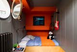 This cubby-like childrens' room features painted wall panelling and built in storage.&nbsp;