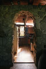 The stone archway at the front of the house opens into a kitchen with custom teak countertops and a big gas oven, which sit opposite a sweeping staircase to the second floor.