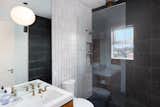 The first bathroom features white subway tile, contrasted with black stone.&nbsp;