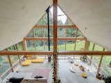 Wooden beams support the ceiling of the A-frame cabin.&nbsp;