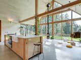 The living room seamlessly gives way to the kitchen, which is anchored by a wood-and-marble island.