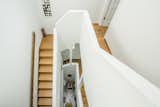 The stairwell embraces the white and wooden elements commonly found in Scandinavian home design.&nbsp;