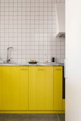 Ana Luisa and Felipe chose a bright, canary yellow for their kitchen cupboards.
