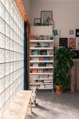 Light flows through the wall of glass bricks and into Ahmed Belkhodja’s apartment on the first floor.