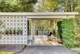 "The covered patio and carport are shielded by a full cinder block facade, with the exterior wall incorporating a decorative block element that allows light to pass through to the patio atrium," states the listing.