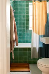 The square green tiles in the bathroom are the same ones architect David Bench used in his own apartment.&nbsp;