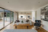 Floor-to-ceiling glazing spans across one of the living rooms, providing easy access to the cedar decking.