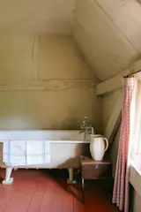 A freestanding, cast-iron soaking tub awaits upstairs near the main bedroom.