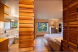 Custom-built wooden details continue into the home’s bedrooms and baths.