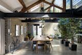 The dining area is bathed in natural light thanks to a glass terrace above, as well as glazed doors, windows, and skylights set into the roof’s pitch.  Photo 7 of 10 in A Design-Driven Loft in a Victorian Omnibus Station Lists for £1.65M