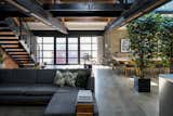 "The design of the space nods to the building’s industrial past," notes the agent. "There are black steel beams and timber roof trusses, brick walls are left exposed throughout, and the concrete floor flows across the main level."