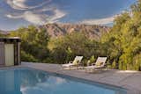 Framing sweeping mountainous views, the Kappe-designed pool, also original to the home, now features new equipment, plaster, tile, and coping.  Photo 10 of 11 in Celebrated Architect Ray Kappe’s First Single-Family Home Is Now Up for Grabs