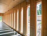 Tall windows positioned along the inner walls of the perpendicular volumes overlook a peaceful courtyard.