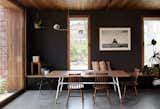 In one space-saving tactic, Chris added a built-in bench with drawers for storage to the dining area. The table is a custom design by Archier, and the chairs are vintage finds. The Jolly pendant hanging above is by Coco Flip. The slender windows are fixed with blinds to block out sun in the summer and can open to create a cross breeze.  Photo 4 of 17 in A Trio of Design Professionals Create a Development of High-Performing Townhouses in Melbourne