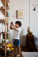 Arthur keeps his collection of toys and books in his bedroom on a shelving unit custom designed by Luke David.
