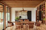 In the dining area, a Guild chandelier hangs above a table and chairs from Carl Hansen.