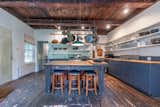 Exposed beams span the kitchen, which comes with a mix of old and new cabinetry.&nbsp;
