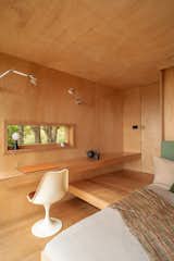 A bed built into the bathroom wall pulls down to replace the sofa. An Olio teapot designed by Barber Osgerby sits on the counter.  Photo 6 of 40 in The 10 Teeniest Tiny Homes of 2022